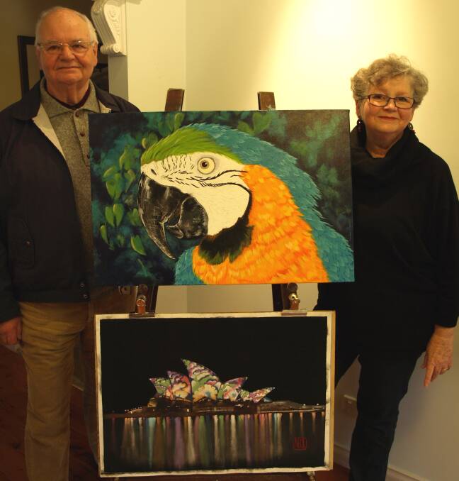 Christine Neal with her Blue Macaw and Brian Neal with his Flower Song. Meet the Olive Tree Gallery’s artists of the month on October 11 from 11am to 2pm.