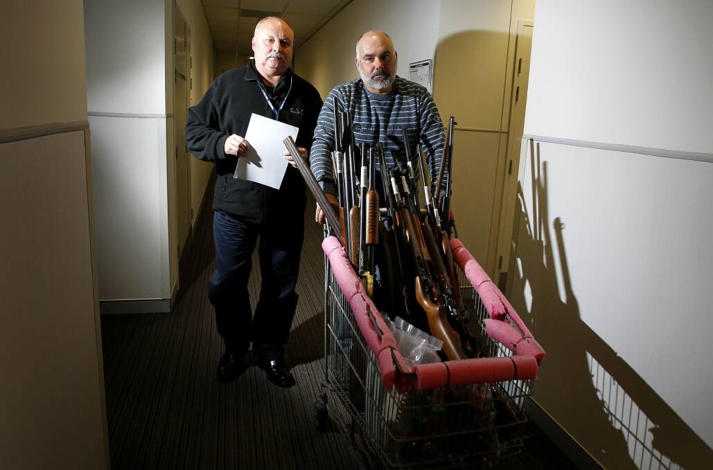Police officers remove a haul of firearms found stashed away in elderly man’s home. Pictures: SYLVIA LIBER
