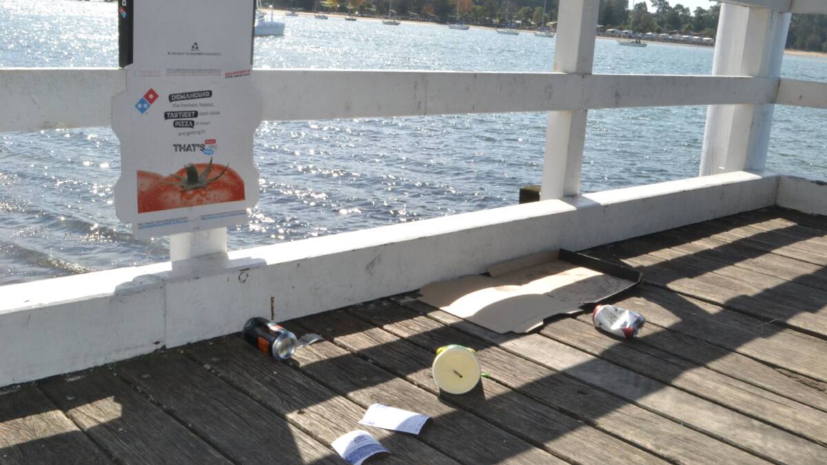 TRASHED: Rubbish left on a foreshore wharf on Thursday. 