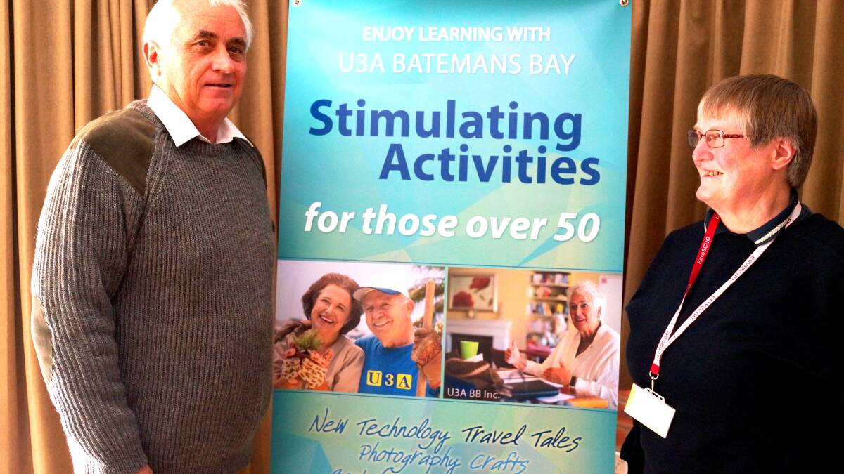 TRAVEL CHAT: Rob Geraghty and Jennifer Hapgood showing off the new, and very colourful, U3A banner at the Saturday talk on August 16 