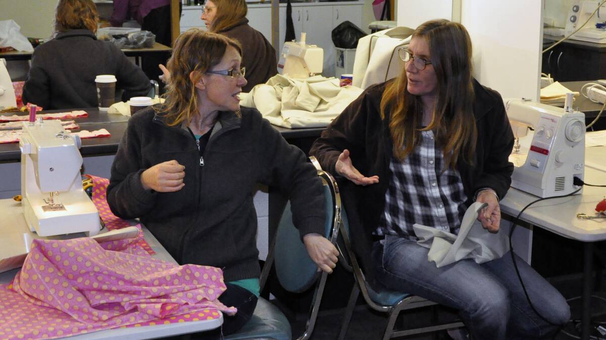 SEWN UP: Charlotte Haslam and Kerry Toyer share a chat while sewing costumes for The Wind in the Willows.
 
