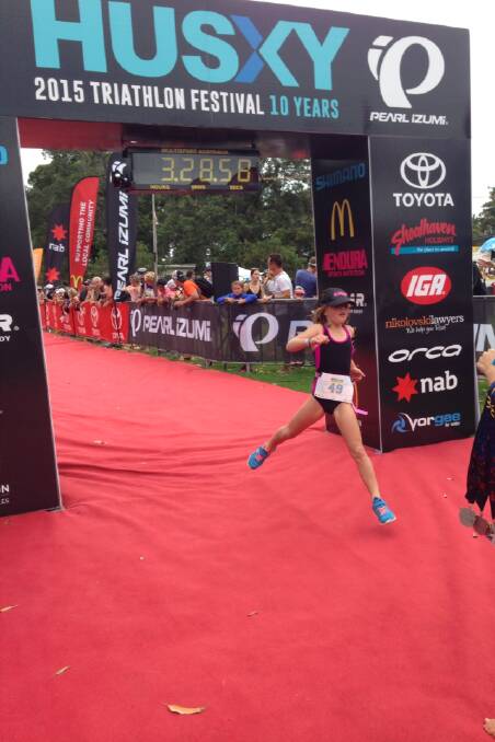 YOUNG GUN: Ruby Connor passes the finish line in the mini man at Huskisson triathlon last weekend.