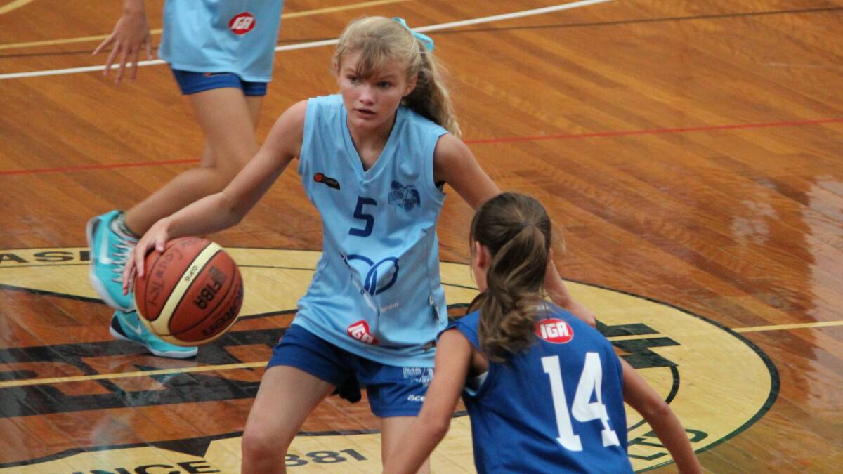 LEAD GUARD: Maddison Blewitt brings the ball up the court for her team at Port Macquarie.