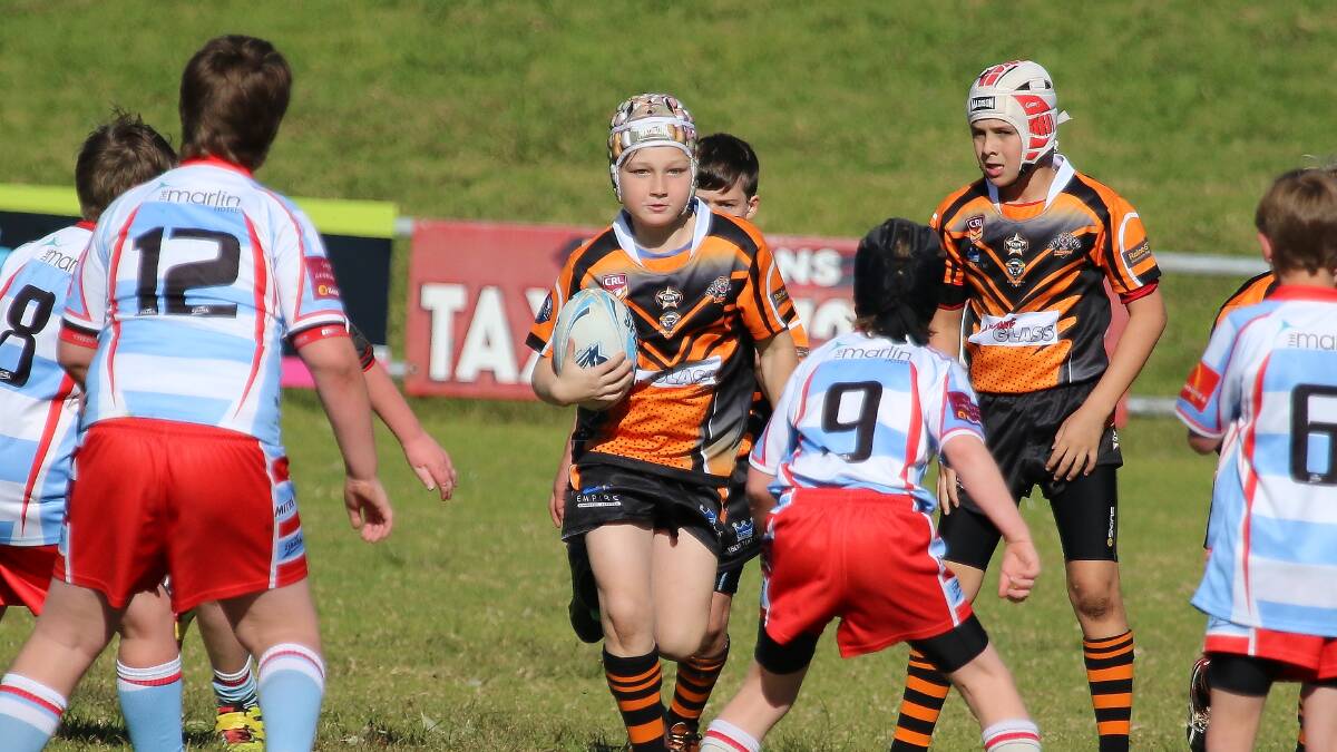 HIT-UP: Batemans Bay Tigers under 10s player Tristian Parsons takes the ball forward for his team. 
