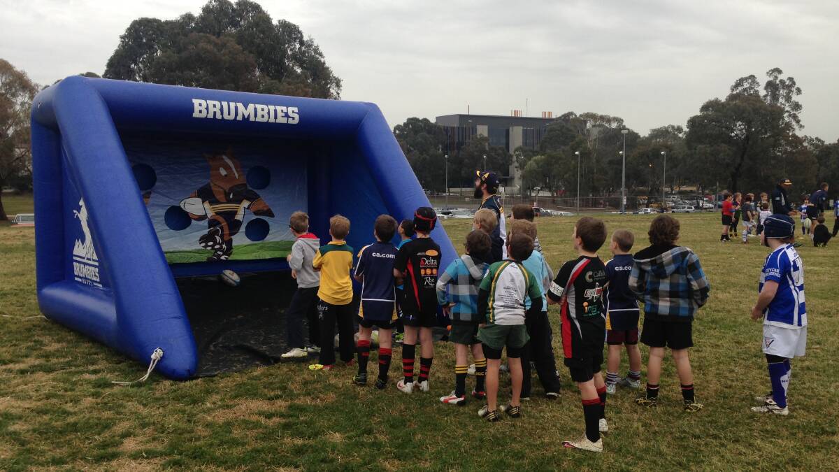 HOLIDAY CLINIC: Children play a passing game at a Brumbies rugby clinic in Canberra. 
