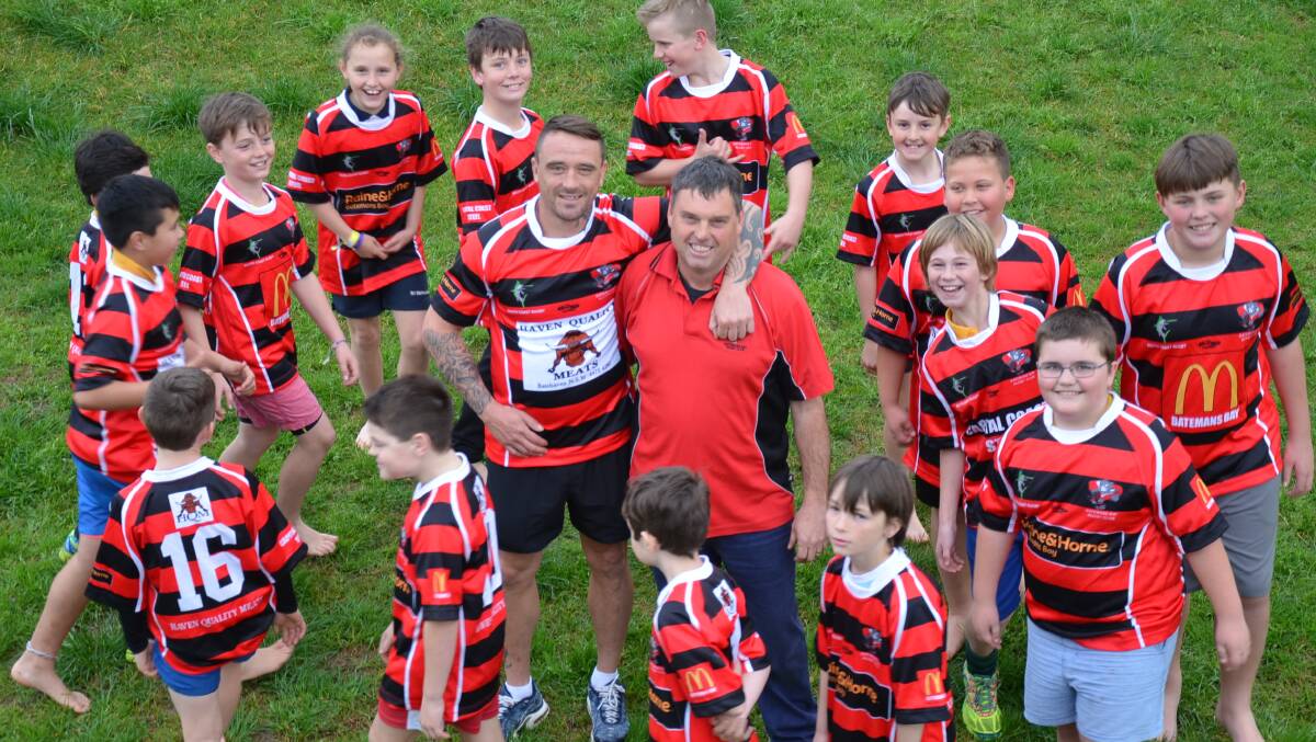 CLUB SPIRIT: Batemans Bay Boars under 11s players and co-coach Cory Maddison circle and celebrate Australian Rugby Union volunteer of the year nominee Ronnie Collier at training on Wednesday. 
