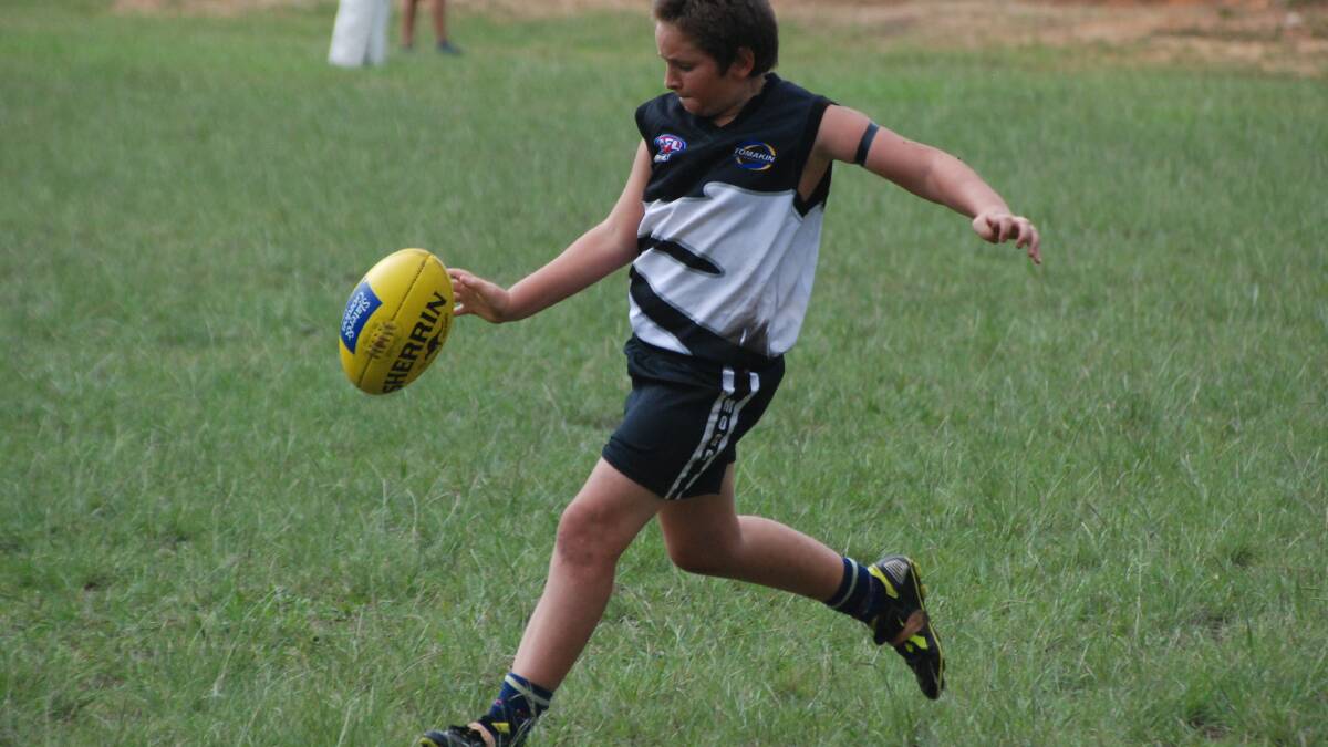 ON THE BALL: Mogo Magic under 16s player Christopher Innocenti gets a kick away against the Bomaderry Tigers on Sunday.