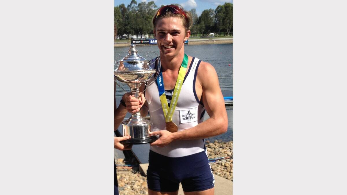 NATIONAL CHAMP: Tom Scott holds the Barrington Cup after his crew won the Schoolboys’ Coxed Eight at the Sydney International Rowing Regatta. 