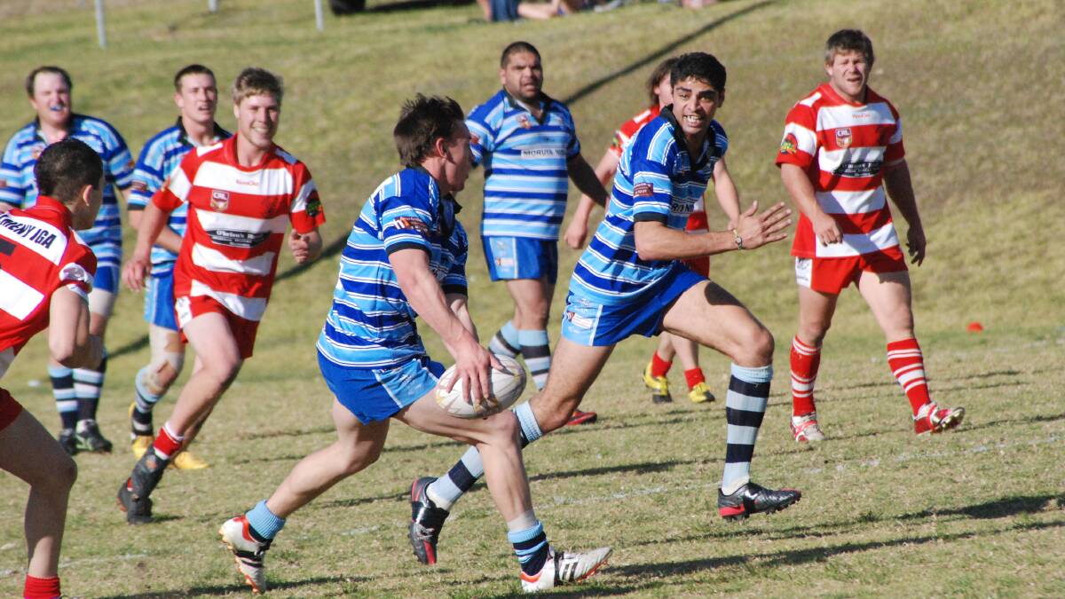 Moruya Sharks’ Jake Clarke flips a pass to Dennis Green against Narooma in August.