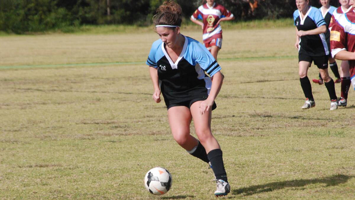 ON THE BALL: Moruya Swans’ Erika Saines dribbles the ball out of her half against Clyde United. 