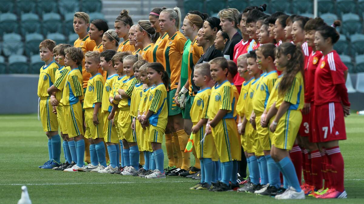 MORE COVERAGE: The Matildas line up for the national anthems before a game against China at Win Stadium in 2014. Photo: Sylvia Liber.
