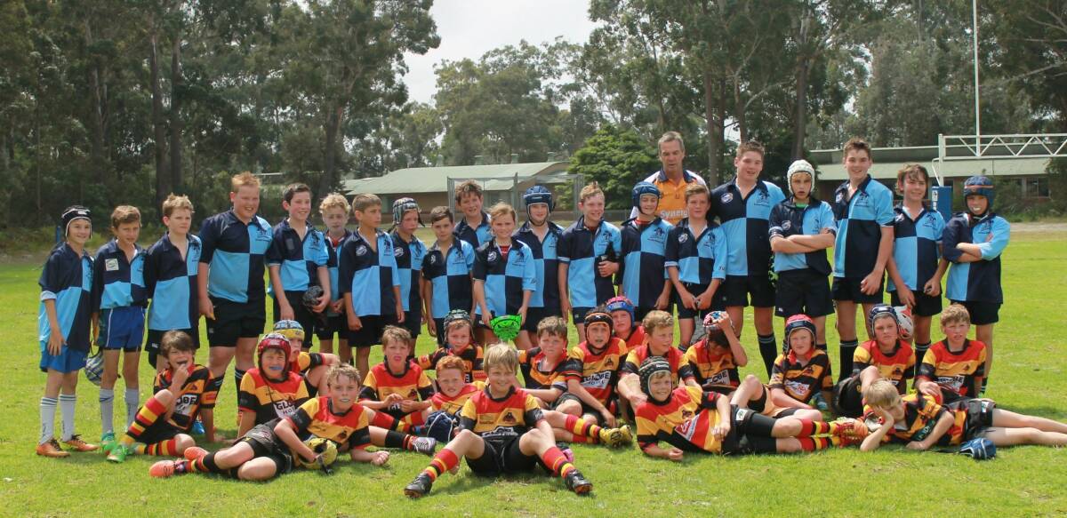 HAPPY CHAPS: Broulee Dolphins’ juniors and Cootamundra’s junior players group together at Captain Oldrey Park. 