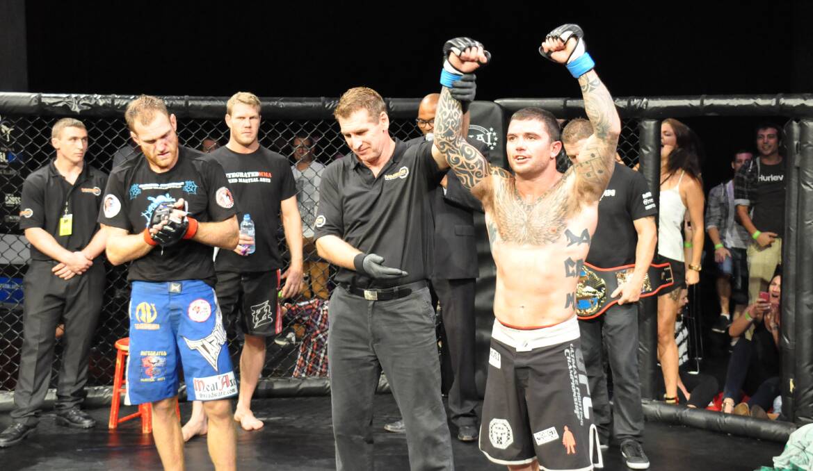 NOWRA: : Shoalhaven’s Craig Martin is officially announced as the winner of the main event at Cage Conquest 3, where he defeated Greg Atzori in a unanimous decision to claim the lightweight title. Photo: PATRICK FAHY  