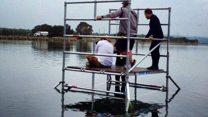 BERMAGUI: The film crew suspended above the water at Wallaga Lake bridge on Monday for the filming of the Angelina Jolie film “Unbroken”.
 