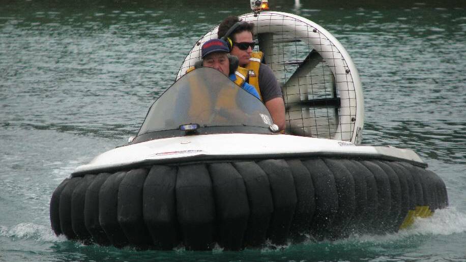 NAROOMA: Australian Seabird Rescue rescuer John Mendham takes Batemans Marine Park ranger Justin Gilligan for a spin around the inlet on one of two new hovercraft used for rescues. 