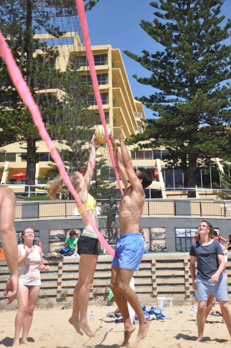 WOLLONGONG : Two players contest the block at the Shoalhaven Beach Volleyball Competition in Wollongong. 