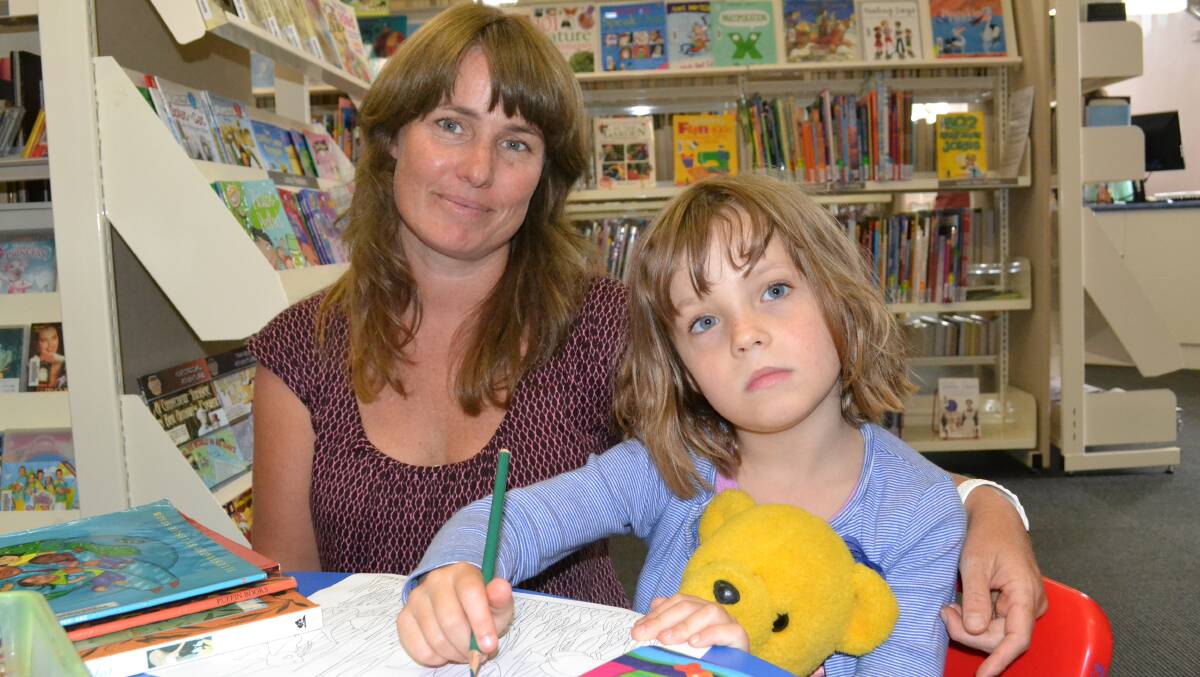 ULLADULLA: Deborah Adcock and daughter Freya from Lake Tabourie love going to the Milton Library, with Deborah saying the size and nature of the library allow her to feel safe looking around while her children amuse themselves reading and colouring in. 