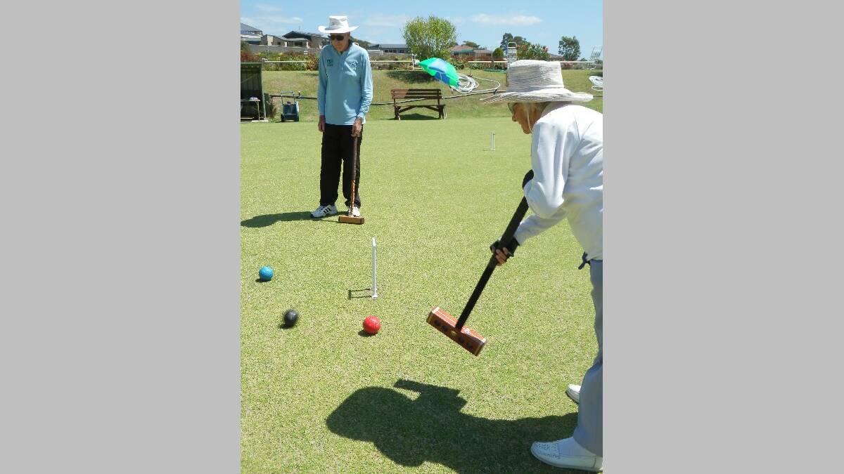 NAROOMA: Peg Terry running hot with opponent Ken Cole in the background at Narooma croquet. 