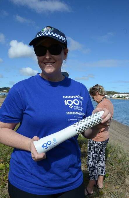 Far South Coast Inspector Angela Burnell with the baton when it passed through Batemans Bay in April.