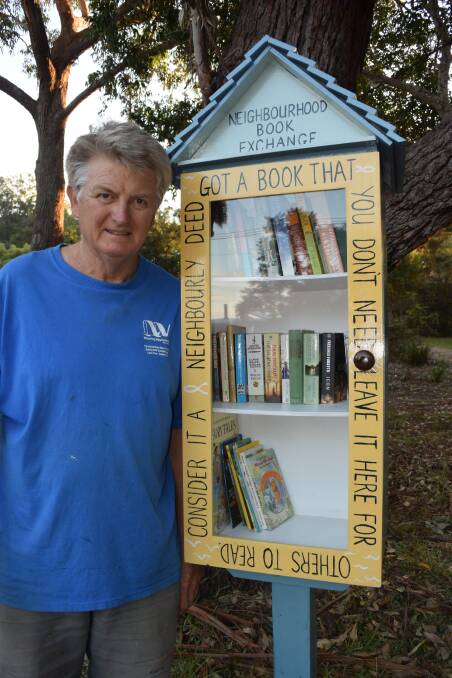 BOOK BOX: Mossy Point resident and Eurobodalla Woodcraft Guild member Mark Barraclough with the latest of the shire’s three book exchange booths.