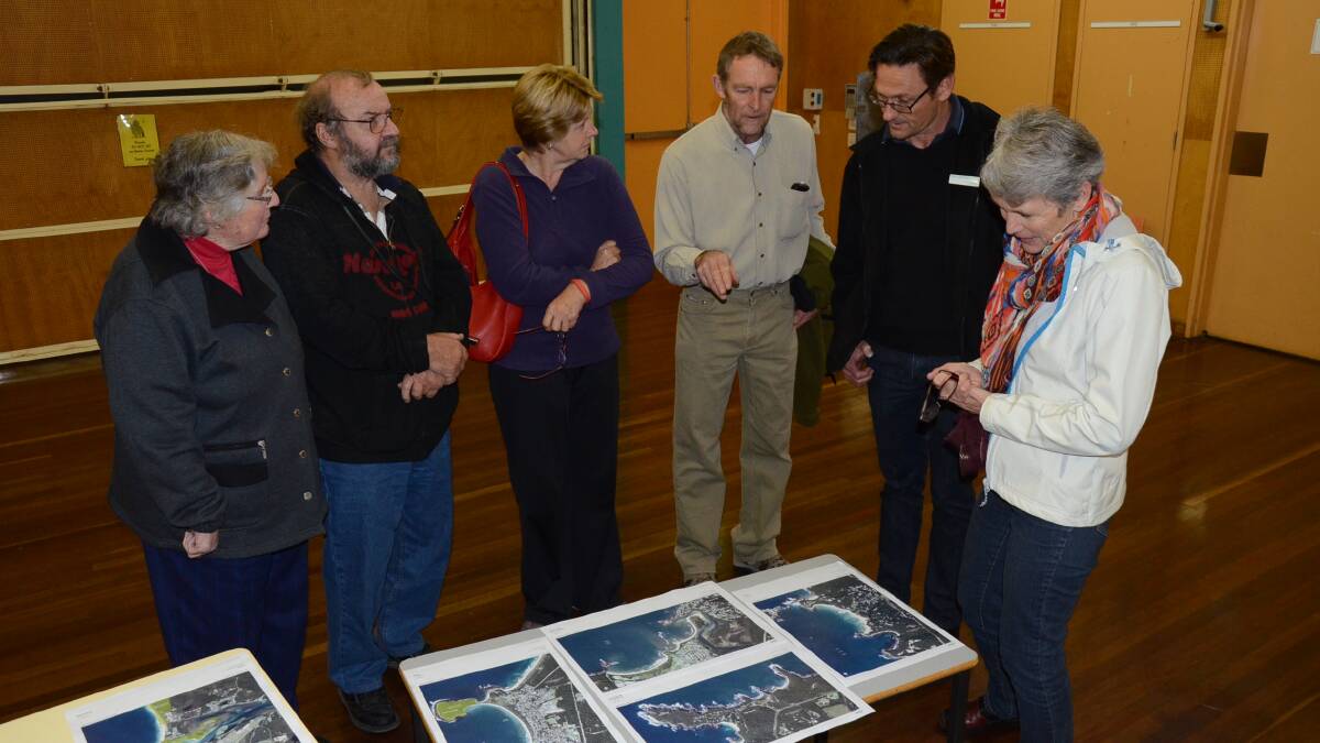SEA CHANGE: Broulee resident Ruth Grace, Tomakin residents Phill and Marg Coltman and Mossy Point’s Matt Gleeson speak with Eurobodalla Shire Council coastal planner Norm Lenehan and Umwelt consultant Pam Dean-Jones about hazards expected to impact the Eurobodalla’s coast at the Broulee meeting.