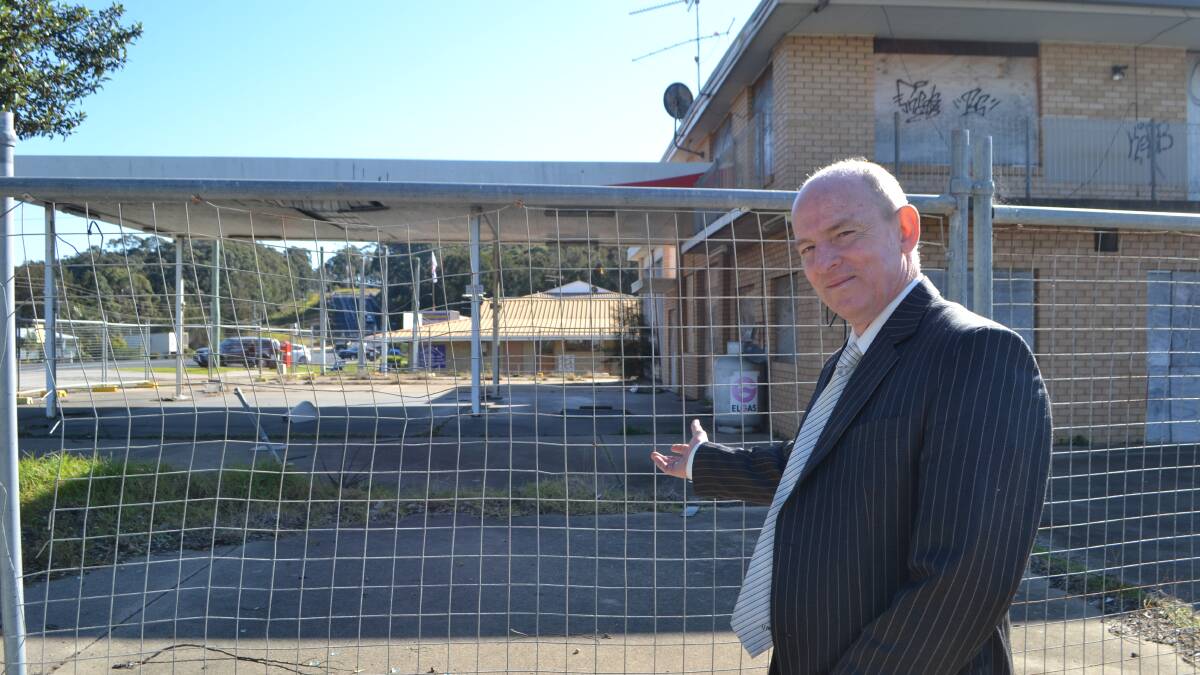 Drew Deck, a sales consultant at LJ Hooker Malua Bay, wants action on the derelict former Malua Bay service station site.