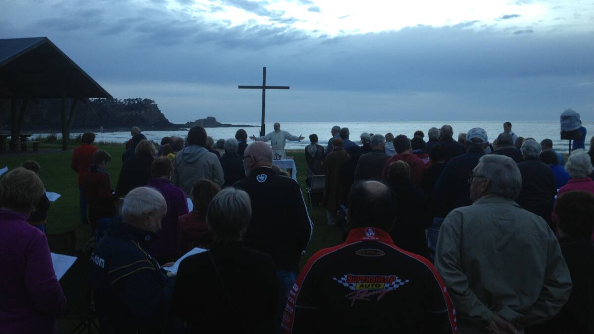 NEW DAY: The Venerable Ian Lambert presides over last year’s Anglican Easter dawn service at Malua Bay.