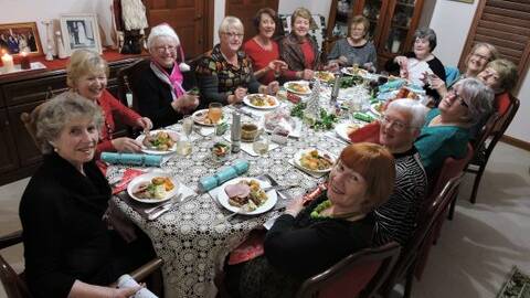 FESTIVE FEAST: Batemans Bay Quota Club members enjoying their Christmas in July dinner.