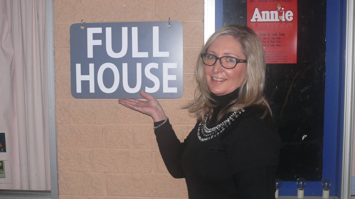 SELL-OUT: Bay Theatre Players’ director Candy Burgess showing off the Playhouse’s house full sign which was put up often during the season of Annie.