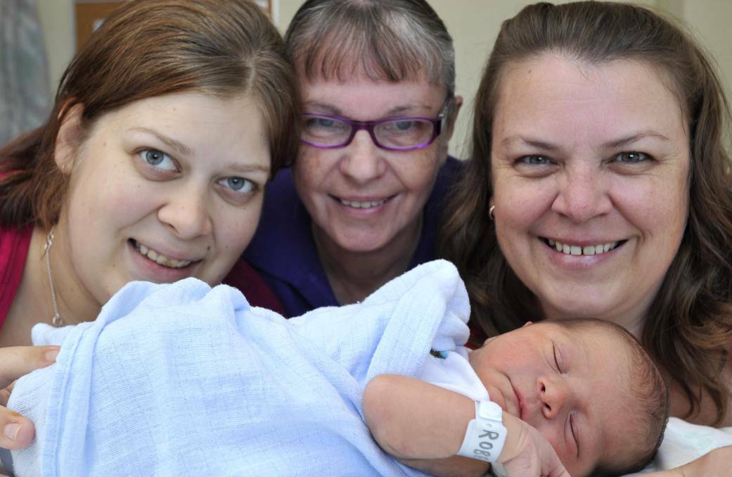 WAGGA: Wagga Base Hospital midwife Mavis Gaff-Smith (centre) delivered her great-grandson Hamish Giovannelli on April 15. Mavis also delivered Hamish's mother - her granddaughter - Hannah Roberts (left) 22 years ago. Hannah, Mavis and Hamish are pictured with Mary-Jo Cutler, Mavis's daughter and Hannah's mother. Picture: Les Smith/The Daily Advertiser