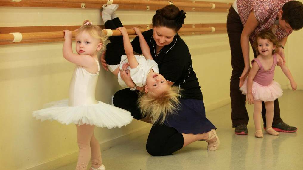 ALBURY: Teacher Keira Gush supports Maurice Brown, 2, as he makes acrobatic use of the barre. Picture: Matthew Smithwick/Border Mail
