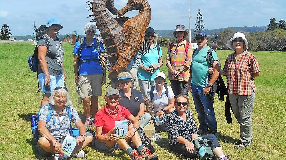 The small group of bushwalkers pose with one of the many Sculptures in Bermagui.