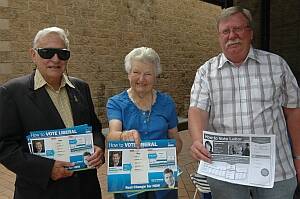 DIFFERENT VENUE:  Moruya Liberal Party’s Nigel and Estelle Neilson and Batemans Bay branch ALP’s Ewan Morrison hand out how to vote pamphlets at the Batemans Bay pre-poll voting centre at the Aboriginal Lands Council in Orient Street.