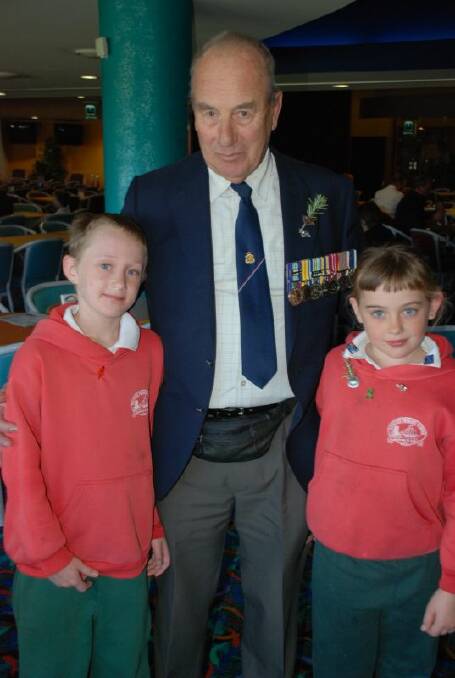 PROUD DESCENDENTS:  Peter Robinson with his grandchildren Peter and Rozlyn Zahra at Tomakin on Anzac Day last year.