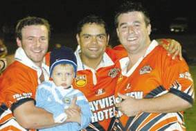 CLOSE ONE: Tigers players Ben Ralston, Dale Wright and Marcelo Loustau (with Wright’s son Jayden) are all smiles after the team pipped Shellharbour by a point on Saturday night.