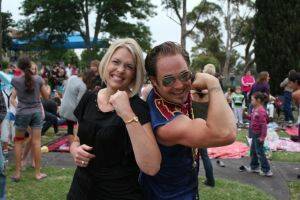 POWER STRUGGLE:  St Mary’s Primary School principal Jacqueline Heffernan flexes her muscles against strongman Roy Maloy’s after she had smashed a huge ice brick on his chest with a sledgehammer - while he lay on a bed of nails!