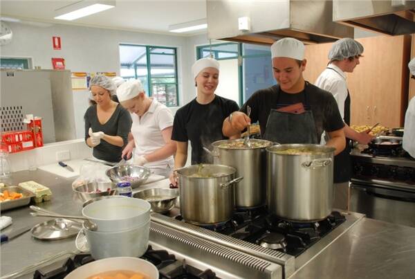 JUNIOR CHEFS: Carroll College hospitality students Sarah Klarica, Emily McNeil, Beth Morgan and Nathan O’Brian prepare food for officials and volunteers at the Australian Surf Rowers’ League Open Championships at Broulee.