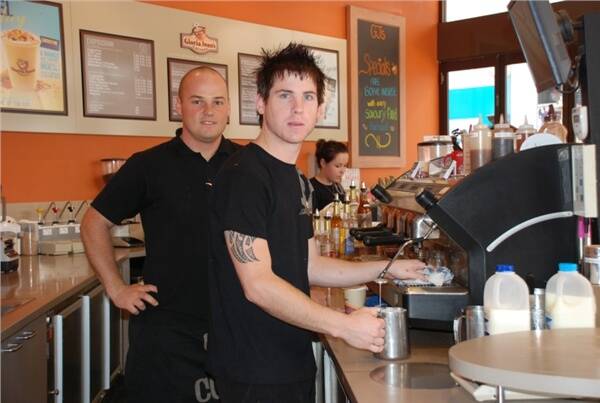 PLAYING SAFE:  Strict workplace safety practices are in place at Gloria Jean’s in Batemans Bay according to assistant manager Chris McInally, who is pictured with casual barista Brett Ellis.