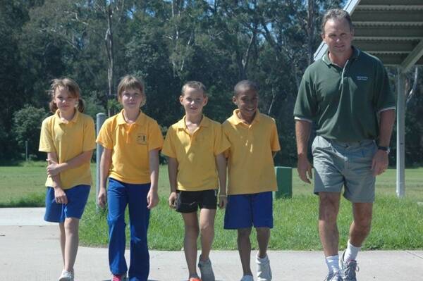 GOOD FOOTING:  Batemans Bay Public School students Katelyn Ryan, Madison Jazszen, Paul Lanfear and Trey Stewart and teacher Michael Williams practise for the Walk to School Safely Day.