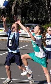 FIRED UP: Waves’ Meg Pritchard and St Peters’ Isabel Starmer prepare to catch the ball at netball at Captain Oldrey Park on Saturday.