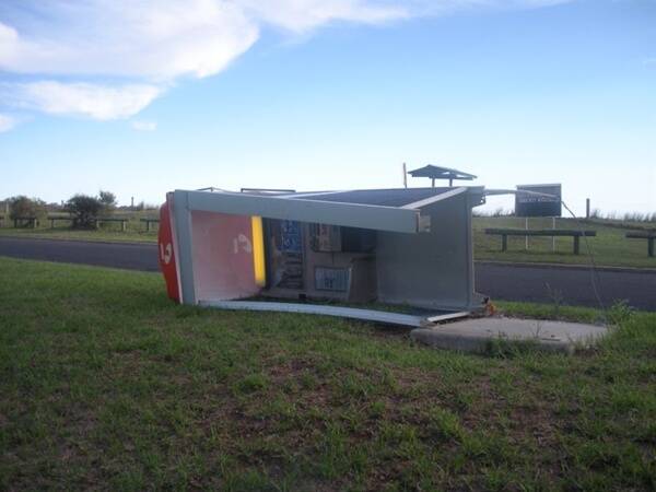 CALL WAITING:  The Telstra payphone at Maloneys Beach was knocked onto its side by vandals recently, and has since been removed.