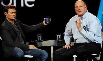 Ryan Seacrest holds the new Nokia Lumia 900 Windows Phone during the keynote address.