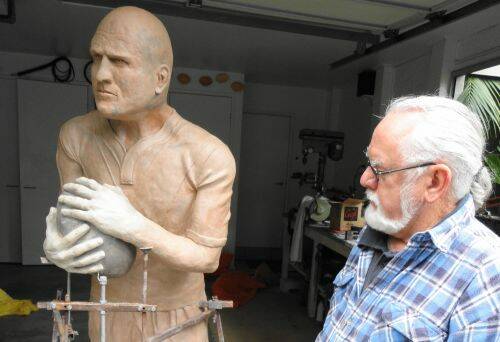 TAKING SHAPE:  Terry Fuller working on the sculpture.