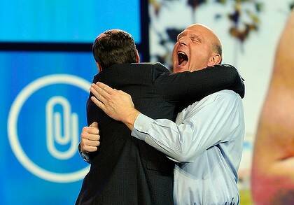 Ballmer hugs host Ryan Seacrest.