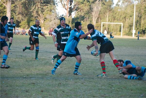 Broulee’s Sean Rose moves in to tackle a Narooma Whales opponent at Captain Oldrey Park on Saturday.