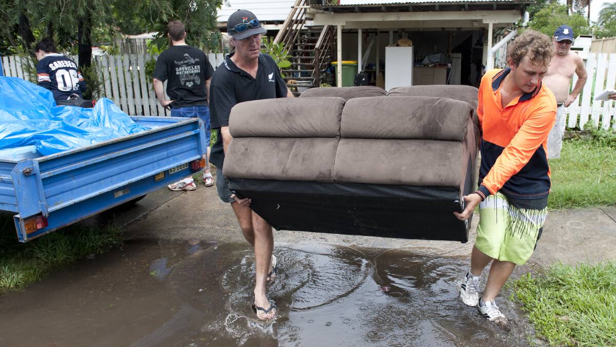 Residents prepare to evacuate Ipswich as others watch flood waters rise near Brisbane. Photo: HARRISON SARAGOSSI