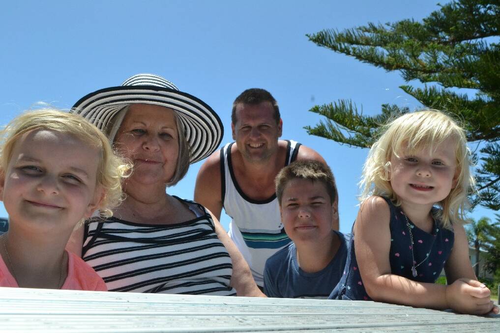 The Shingles family travelled from Perth to enjoy the sun on Monday at Corrigans Reserve. Chrissy, 4, and Caitlin, 2, are pictured with their grandmother Penny, father Shane and Mitchell Shingles, 11. The family was visiting Penny’s brother, Lawrie Smith, of Batemans Bay.