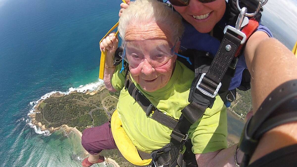 BRAVE FACE: Ilma Sinclair of Batemans Bay on her sixth skydive with Jules McConnell from Skydive Oz.