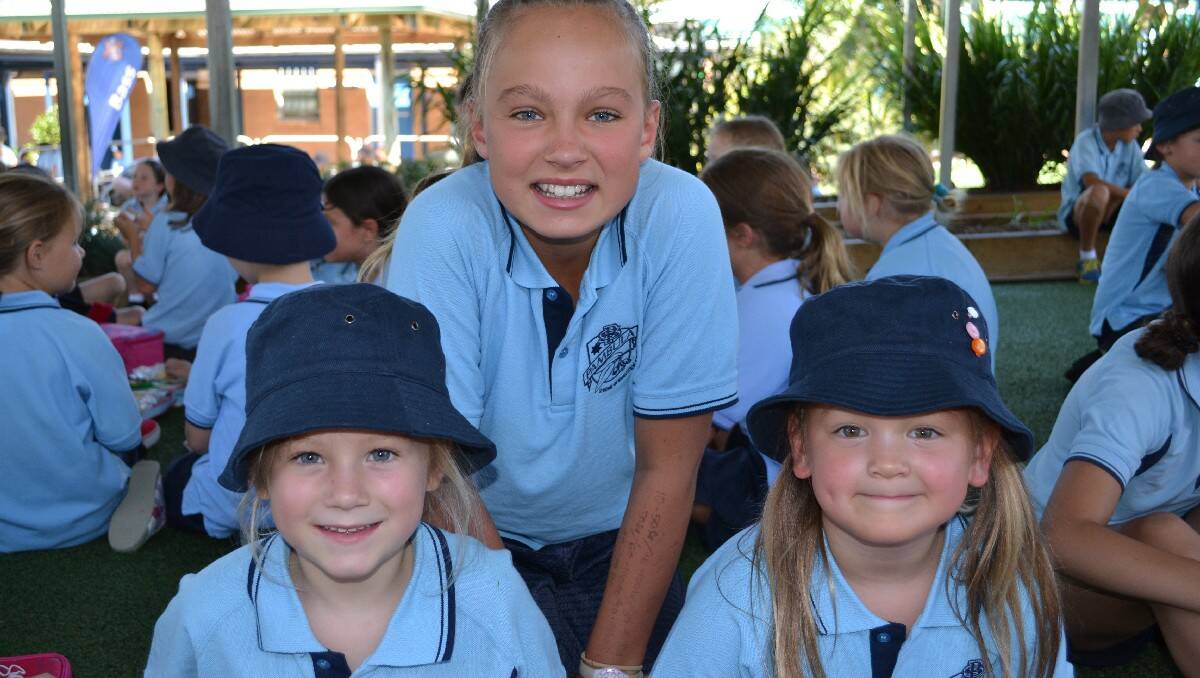 PAMBULA: First day at school for Pambula PS kindergarten students Ivy Hassell, left and Ella Bownds with year 6 buddy and school prefect Georgia Brain.  
