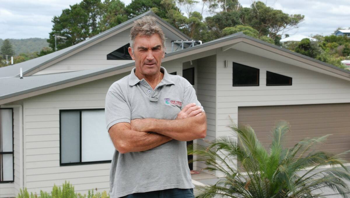 FIX IT: Eurobodalla builder and designer Michael Johnson has been in the industry for 30 years and believes a culture within council is to blame for the downturn in building approvals. He is pictured in front of a house he designed and built that he alleges was held up in council for 12 months.